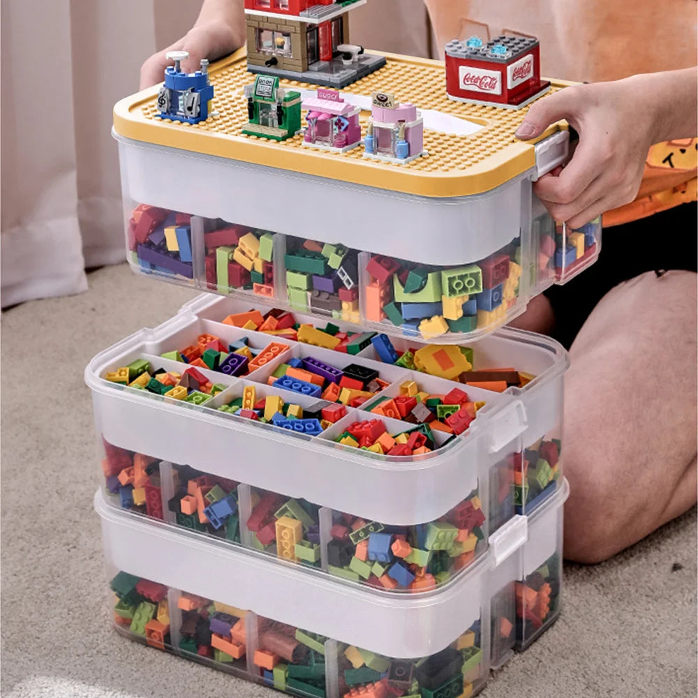 Stackable toy storage bins with colorful building blocks on a carpeted floor.