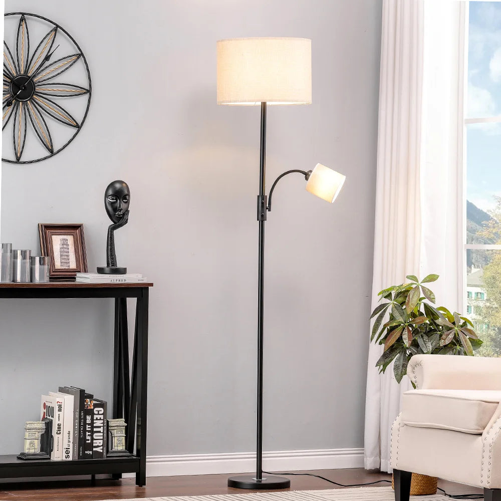 Floor lamp in a living room setting with a reading light on a gray wall.