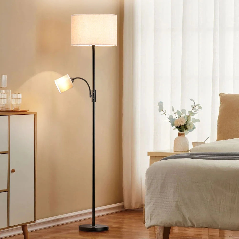 Floor lamp in a bedroom setting with a bed and window in the background