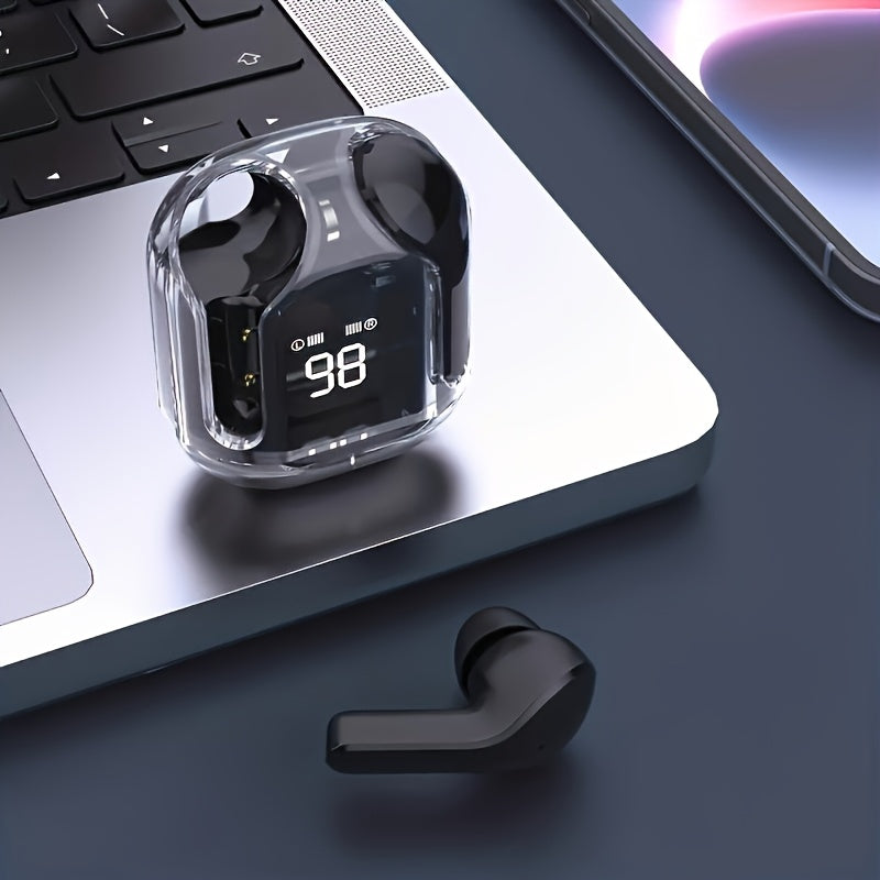 Black wireless earbuds with charging case on a laptop