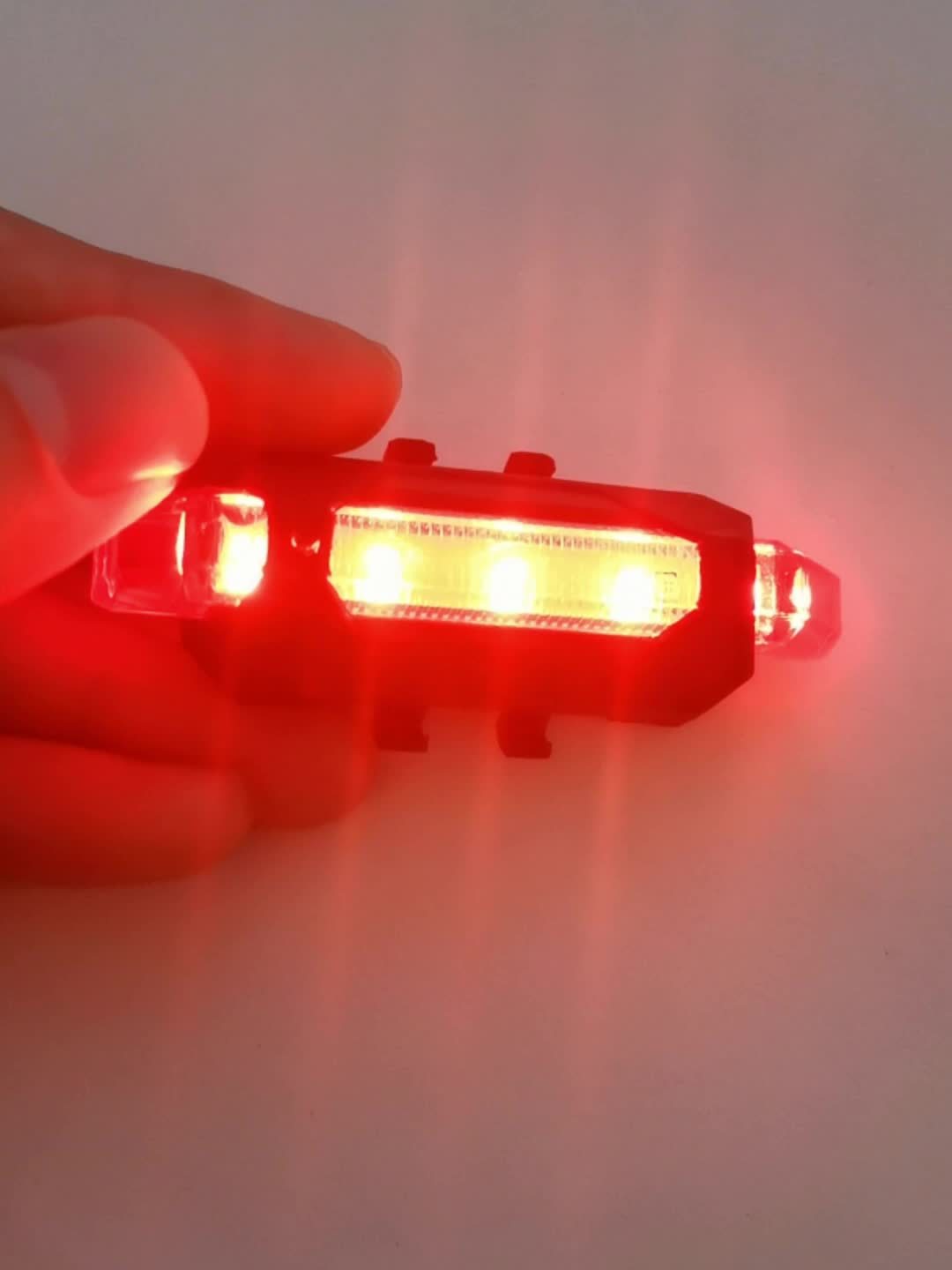 Red LED light held by a hand against a white background