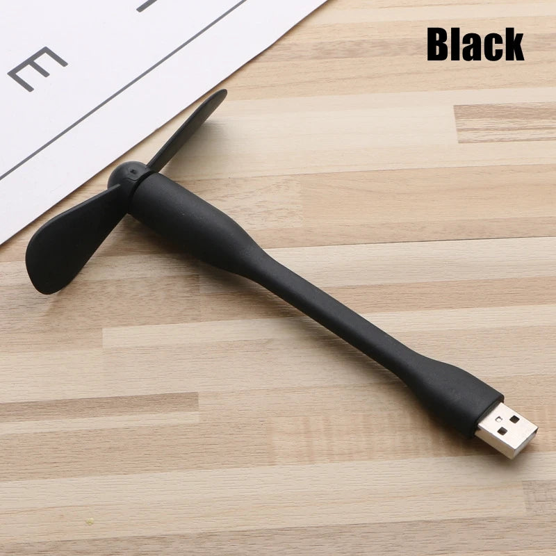 Black USB fan on a wooden surface with 'Black' text above.