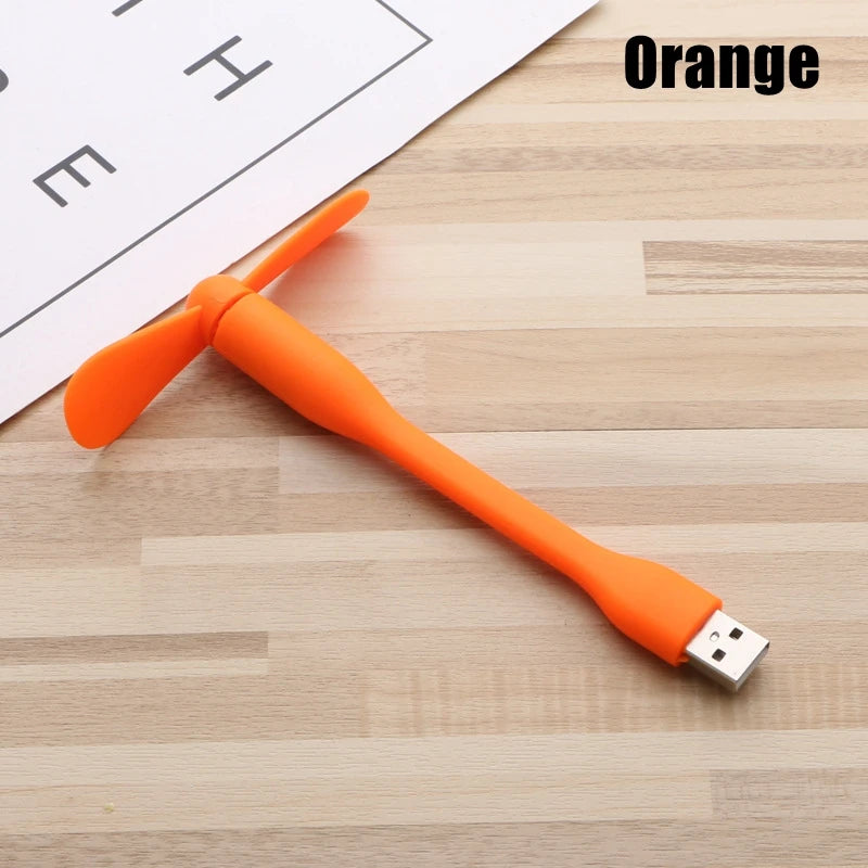 Orange USB cable on a wooden surface with 'Orange' text above.