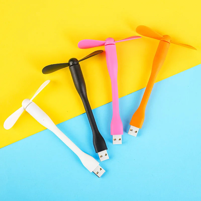 Four colorful USB fans on a yellow and blue background