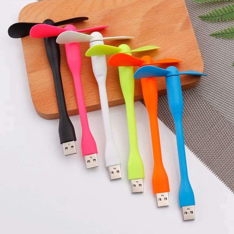 Colorful USB fans on a wooden board with a white background