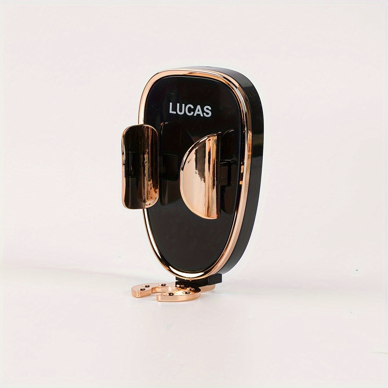 Black and rose gold phone holder with 'LUCAS' branding on a light gray background