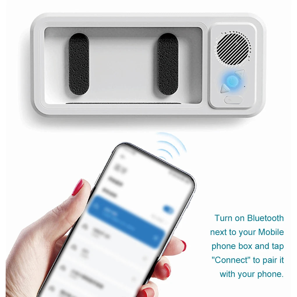 White electronic device with Bluetooth connectivity feature, shown with a smartphone.