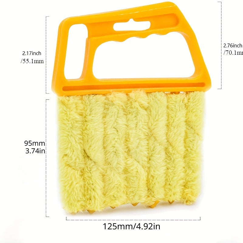 Yellow scrubber with orange handle and measurements on a white background