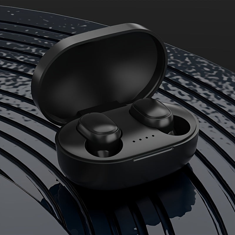Black wireless earbuds in a charging case on a reflective surface