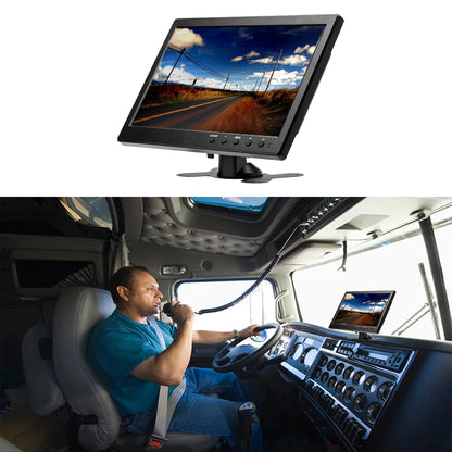 Driver inside a vehicle with a monitor displaying a scenic road view.