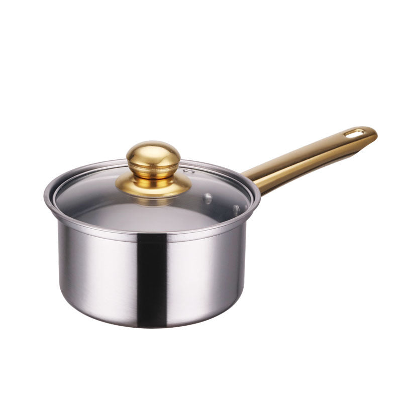 Stainless steel saucepan with a gold handle and lid knob on a white background