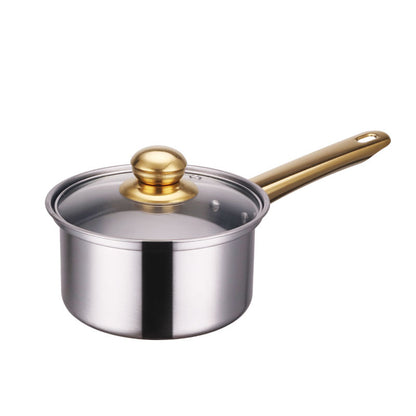 Stainless steel saucepan with a gold handle and lid knob on a white background