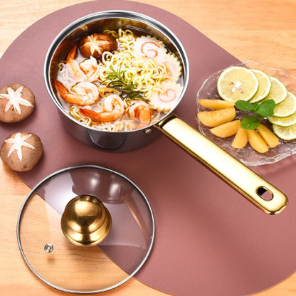 Stir-fry pan with noodles and seafood on a wooden surface with fruits and vegetables.