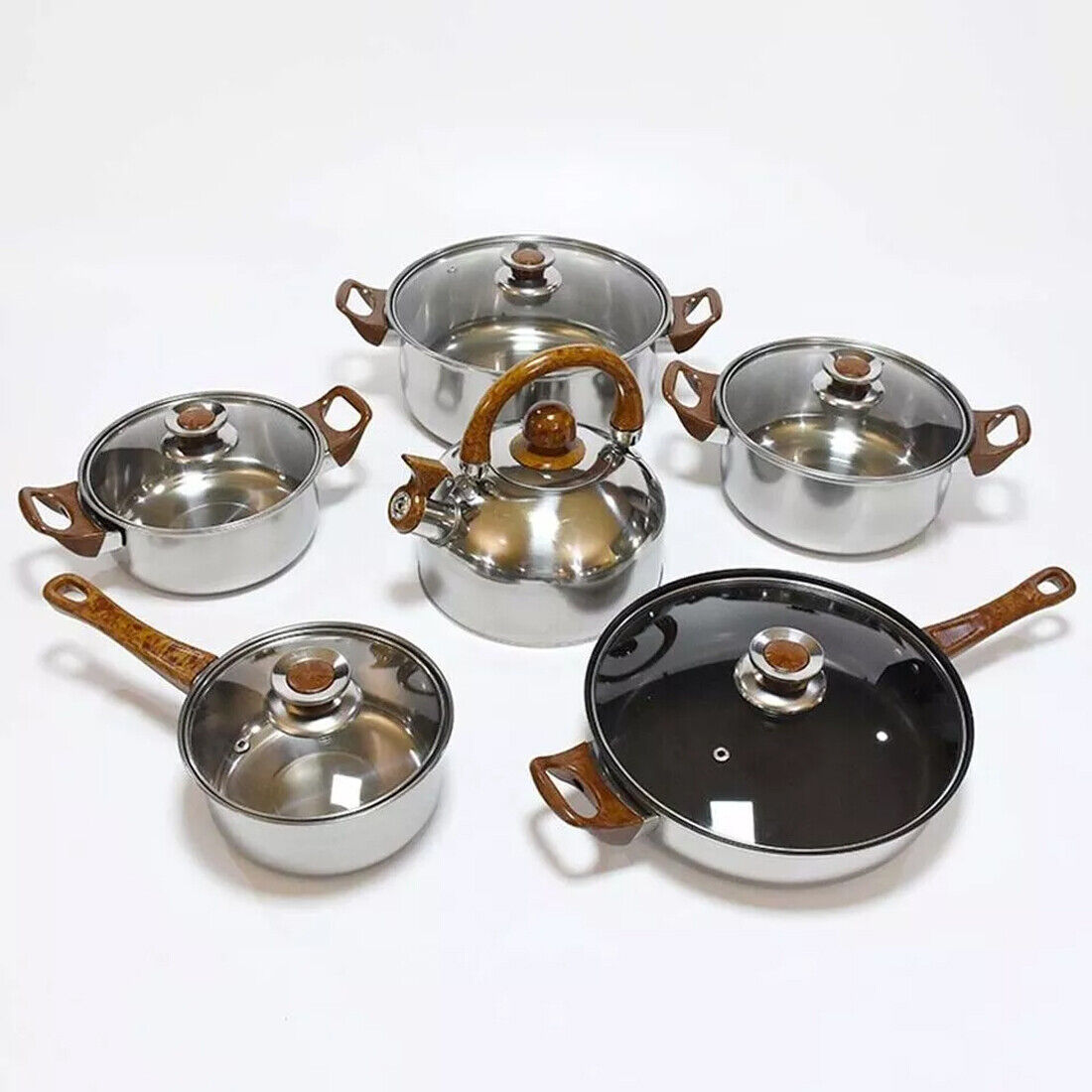 Set of metallic cookware with brown handles on a white background