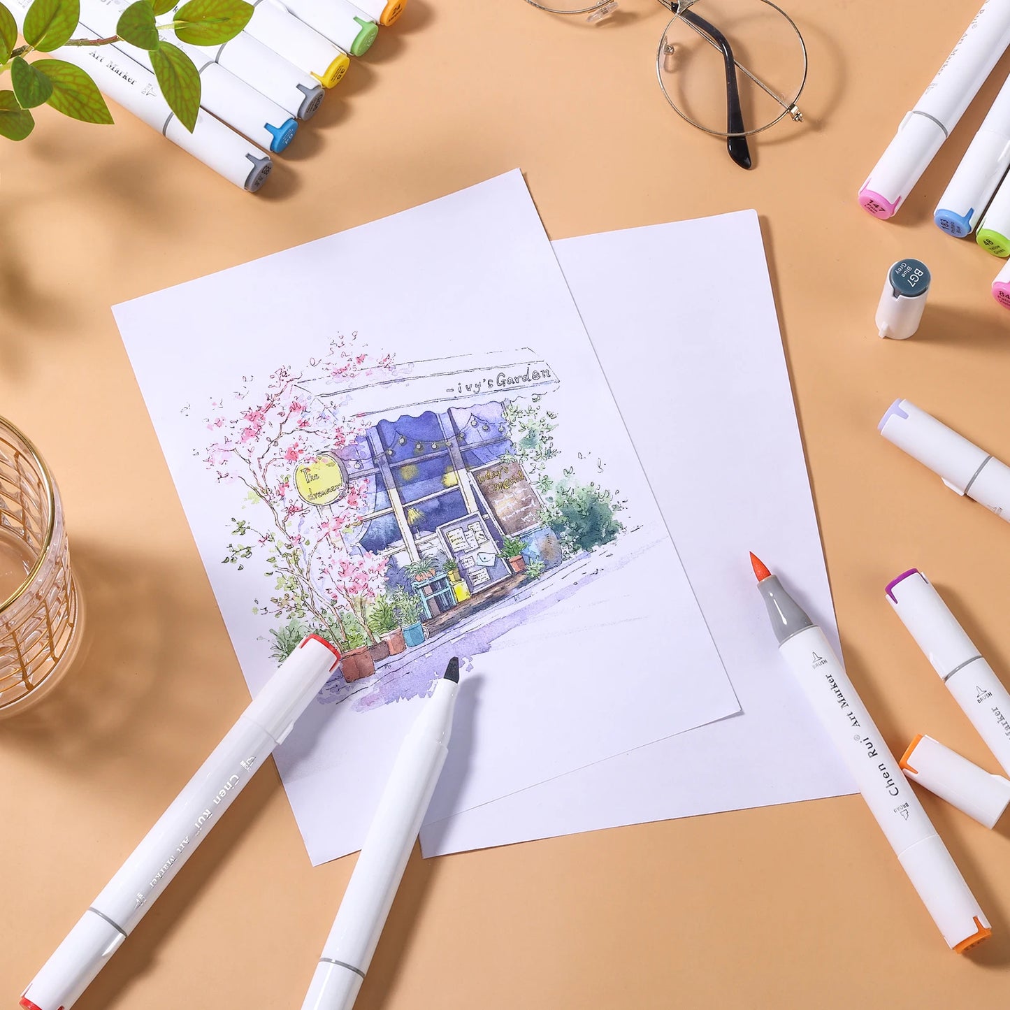 Coloring book with a house illustration on a table with markers and glasses