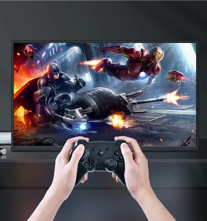 Person playing a video game with a controller in front of a screen displaying superhero action.