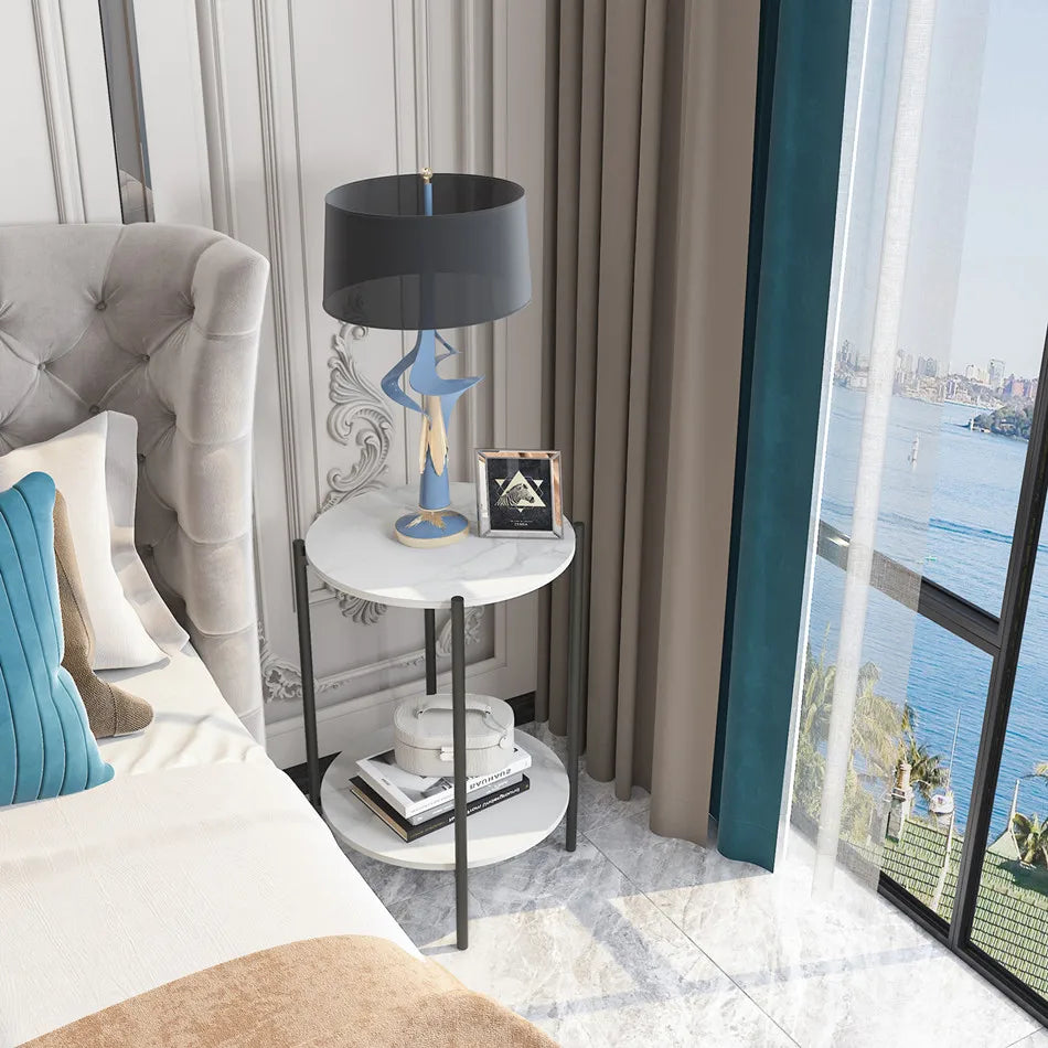 Modern bedroom with a bed, side table, lamp, and city view.
