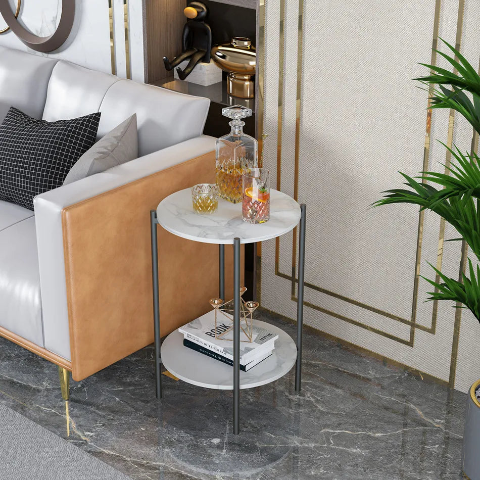 Small round side table with marble top in a living room setting.