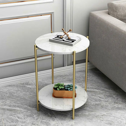 Small round marble table with gold legs in a living room setting