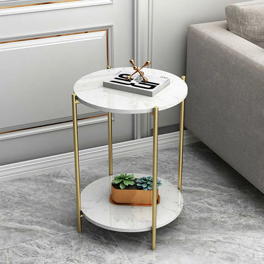 Small round marble table with gold legs in a living room setting