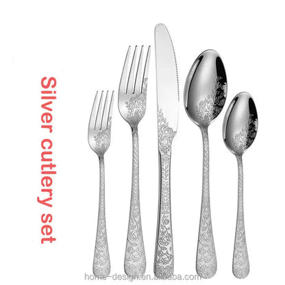 Silver cutlery set with floral patterns on a white background