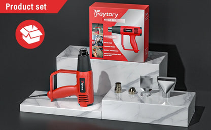 Feytory heat gun set with gun, nozzles, and packaging on a marble stand.