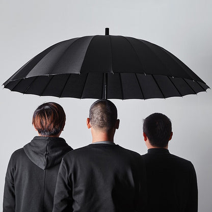Three Men Under Large Black Umbrella