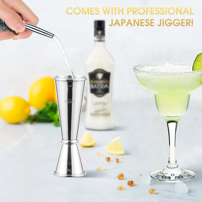 Cocktail shaker with a bottle and glass in the background, featuring text about a professional Japanese jigger.