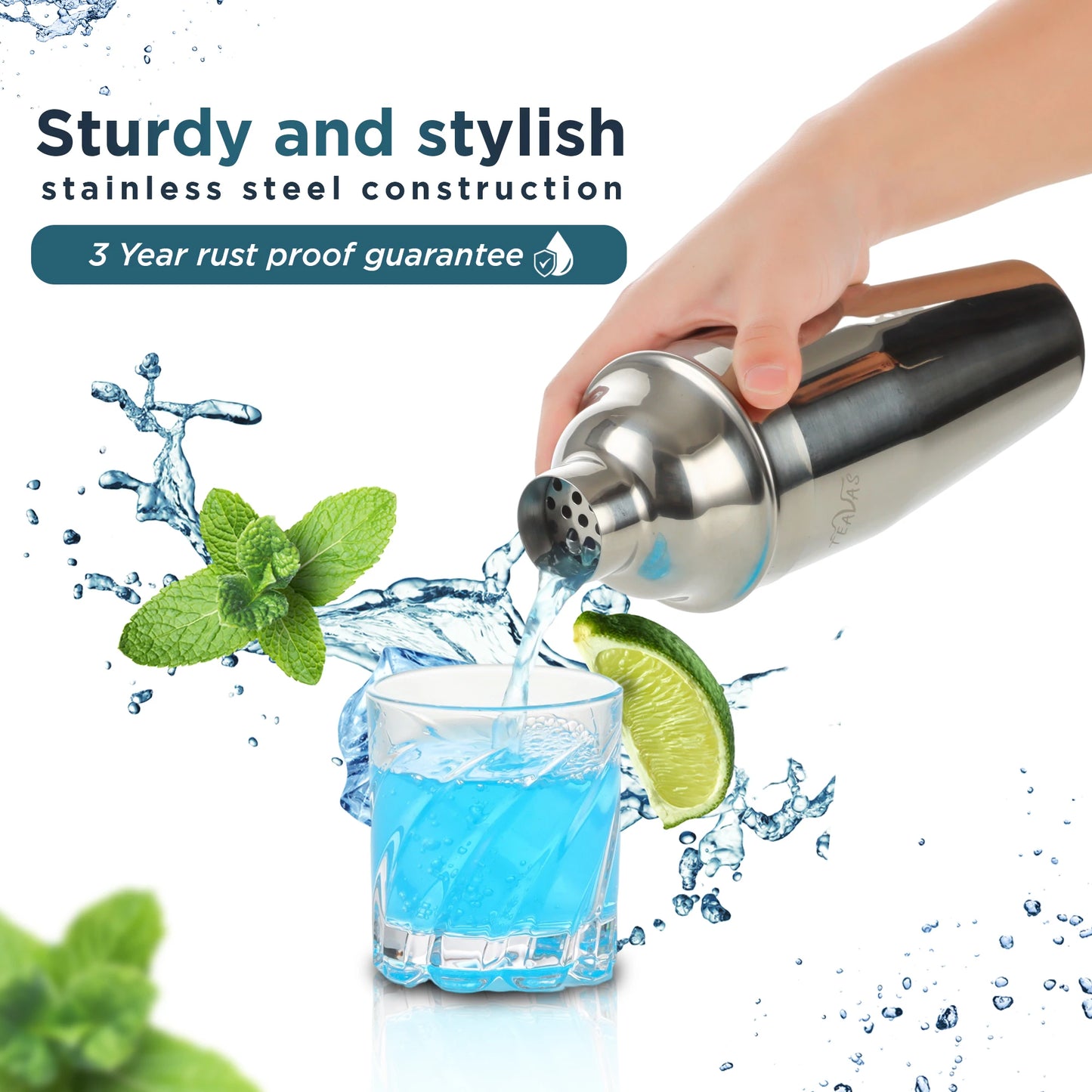 Stainless steel cocktail shaker being used to pour a blue drink into a glass with lime and mint garnish, on a white background.