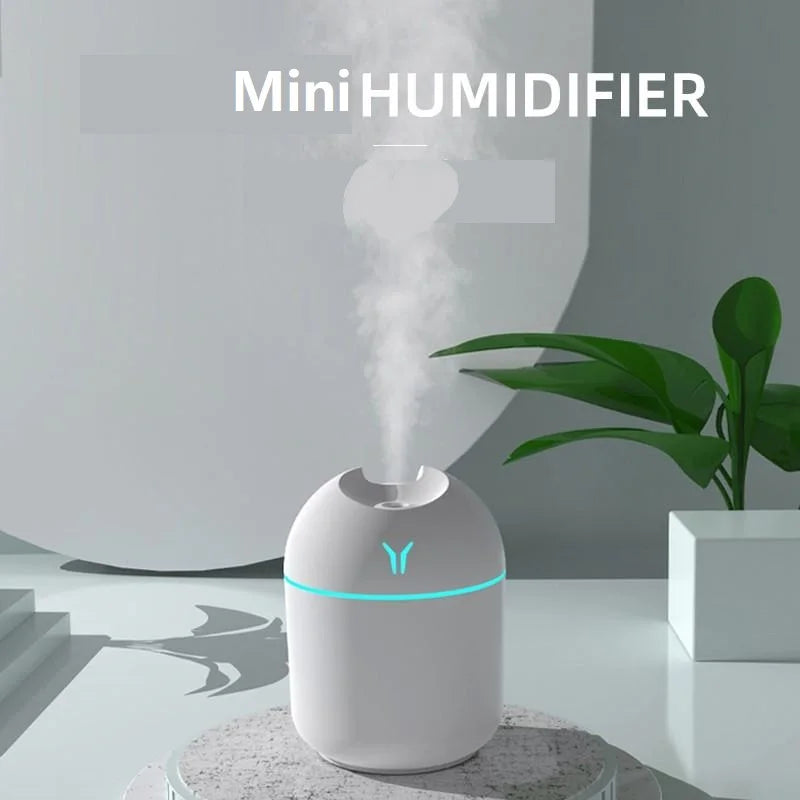 Mini humidifier emitting steam on a modern interior background with a plant.