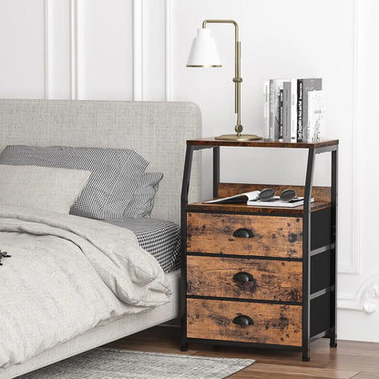 Wooden nightstand with three drawers next to a bed in a bedroom setting.
