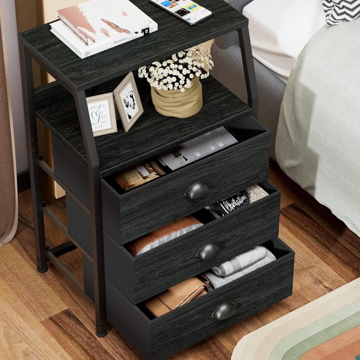 Black nightstand with multiple drawers in a bedroom setting