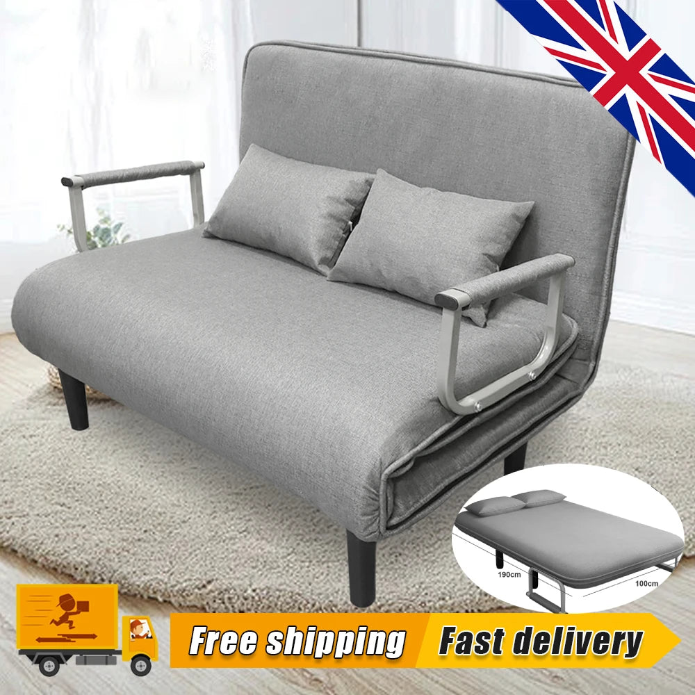 Gray sofa bed with cushions on a light wooden floor, with a British flag in the corner.