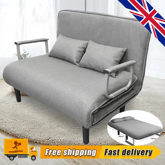 Gray sofa bed with cushions on a light wooden floor, with a British flag in the corner.