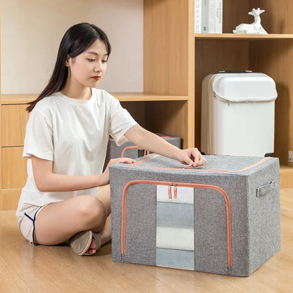 Woman sitting on the floor with a large gray storage box in a room with wooden shelves.