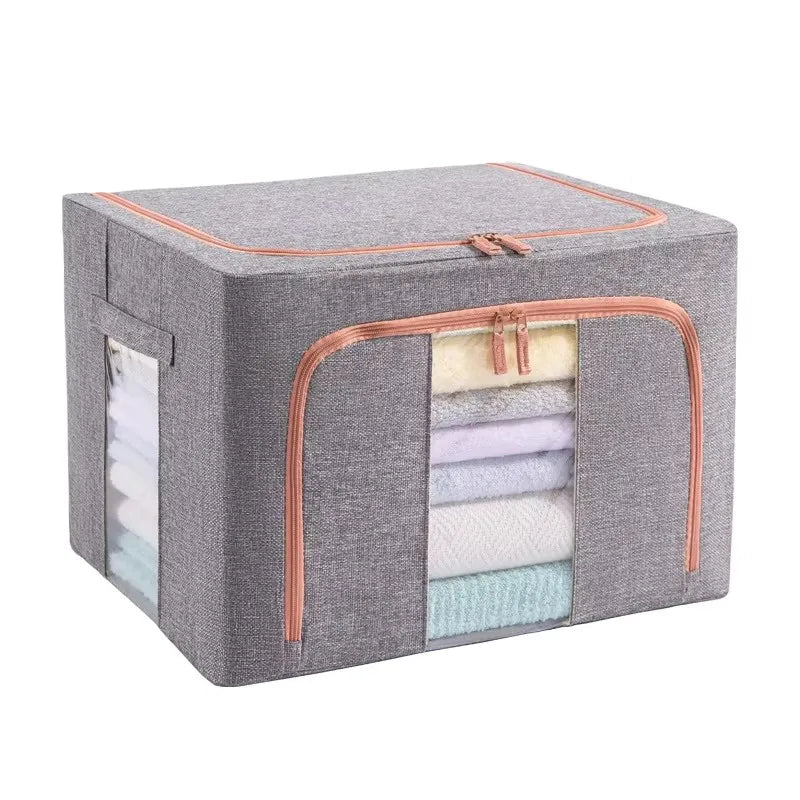 Gray storage box with pink trim containing folded clothes on a white background