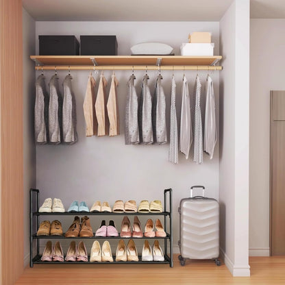 Closet with hanging clothes, shoes on shelves, and a suitcase.