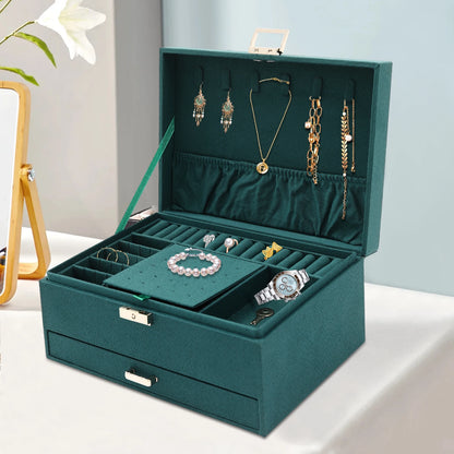 Teal jewelry box with various jewelry items on a light background
