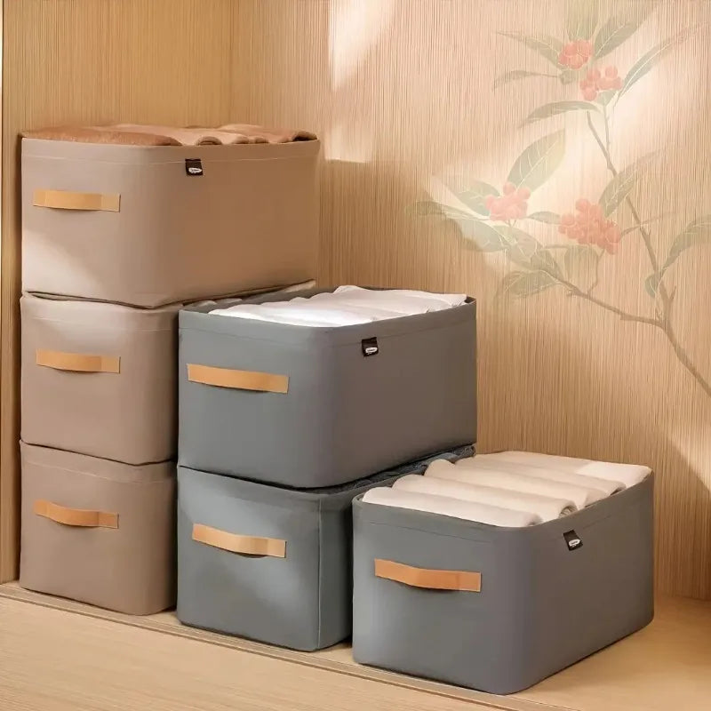 Set of storage boxes with lids on a wooden floor against a floral-patterned wall.