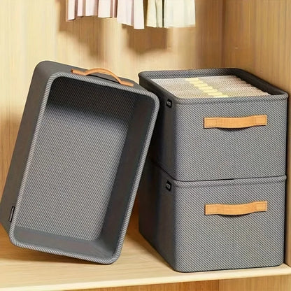 Gray storage bins with brown handles on a wooden surface