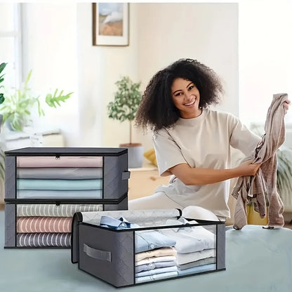 Woman organizing folded clothes in transparent storage boxes in a bright room.