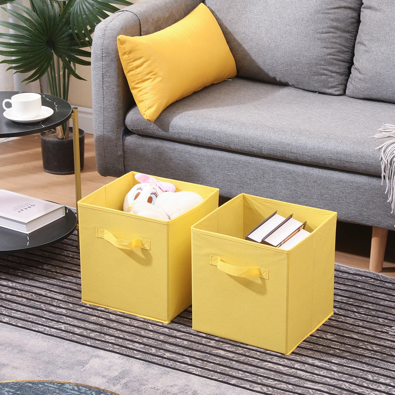Two yellow storage cubes in a living room setting with a gray sofa and coffee table.