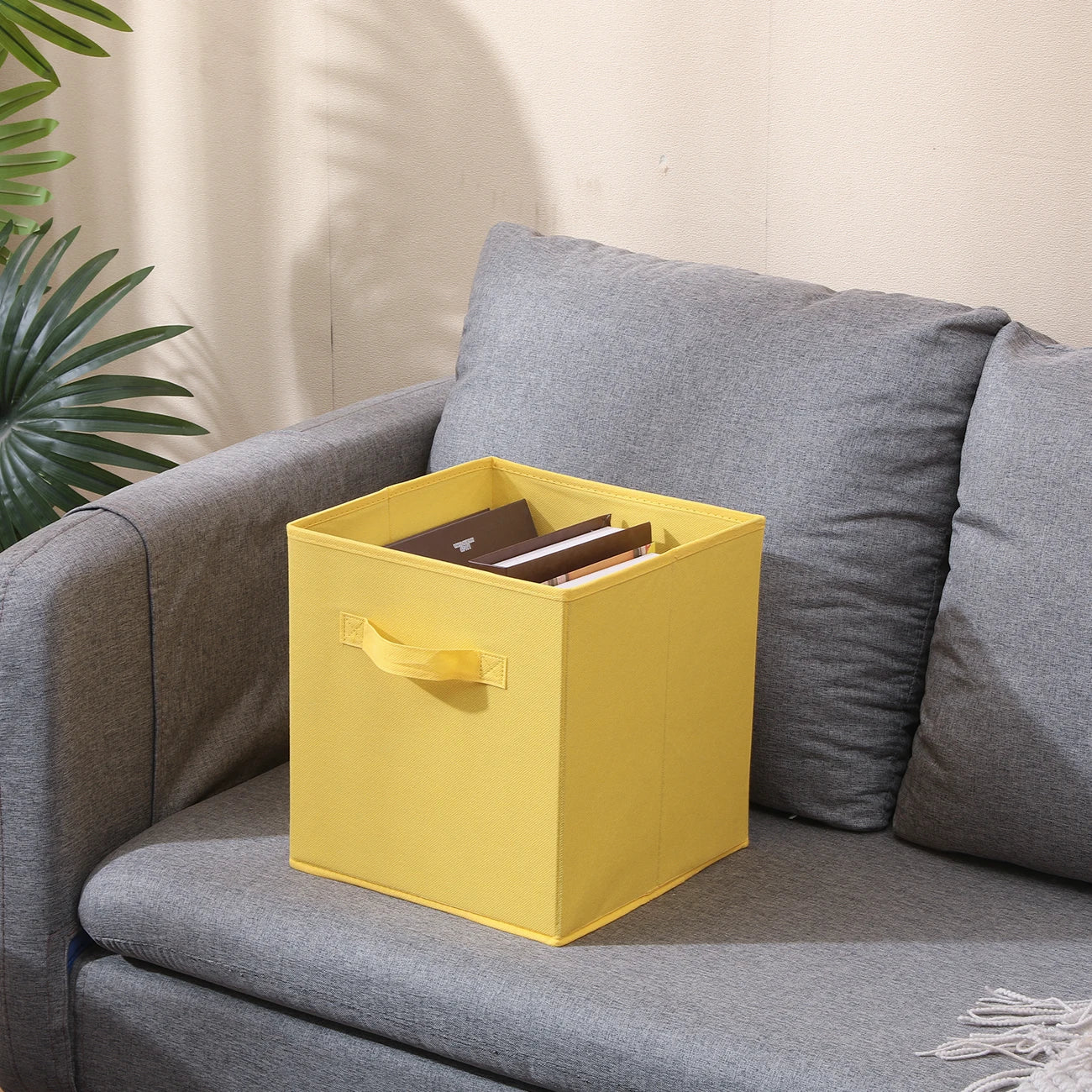 Yellow Storage Cub Box on a Grey Sofa
