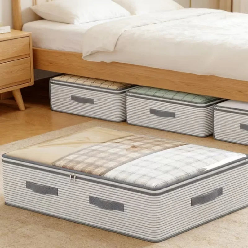 A set of striped fabric under-bed storage bins and a matching floor storage bin arranged under a wooden bed frame in a bedroom setting.