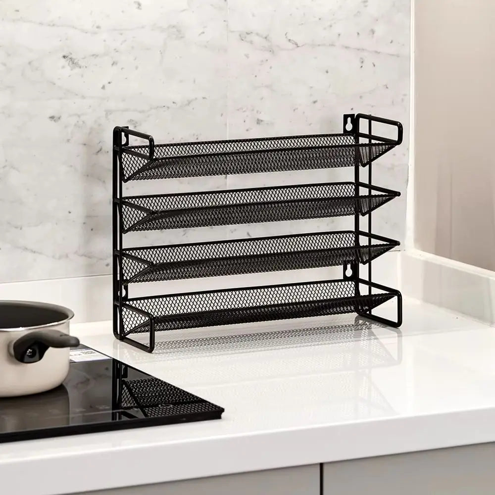 Black mesh wall-mounted organizer on a kitchen counter with a marble backsplash.