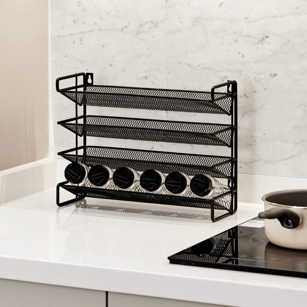 Black mesh spice rack on a kitchen counter with a marble wall background