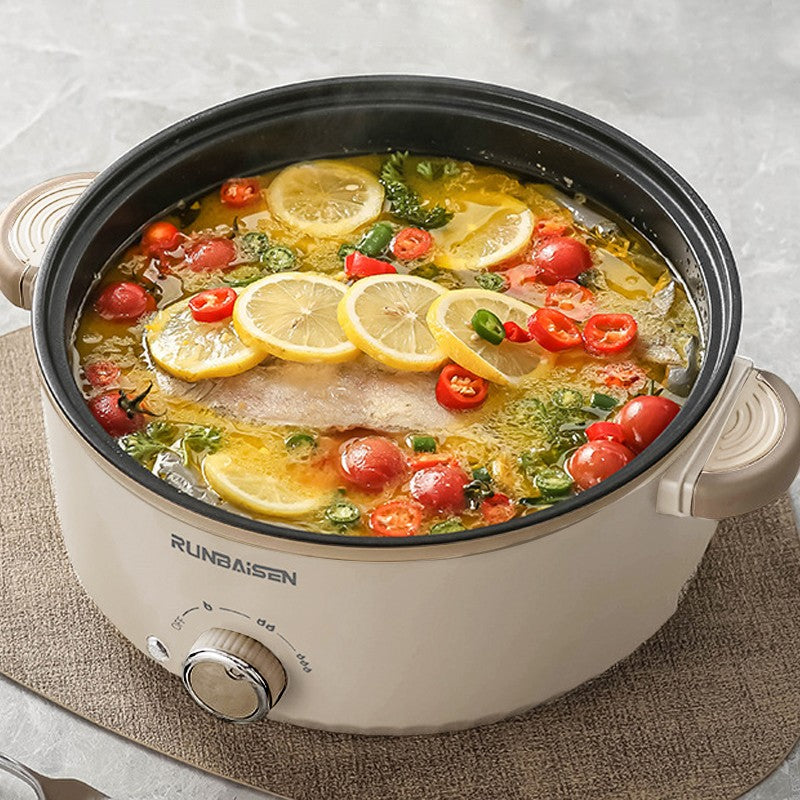 Crockpot with fish and vegetables on a textured surface