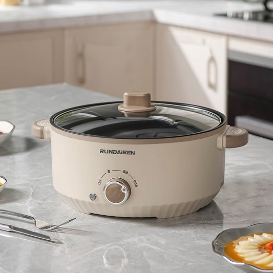 Beige electric pot with glass lid on a kitchen counter