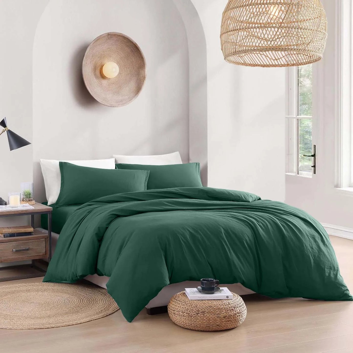 Green bedding set on a bed in a bedroom with wicker lampshades and decor.