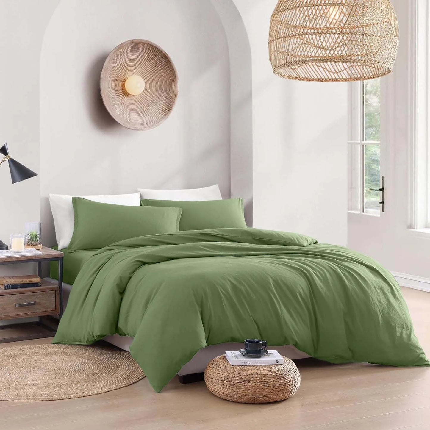 Green bedding set on a bed in a bedroom with wooden floors and decorative lamps.